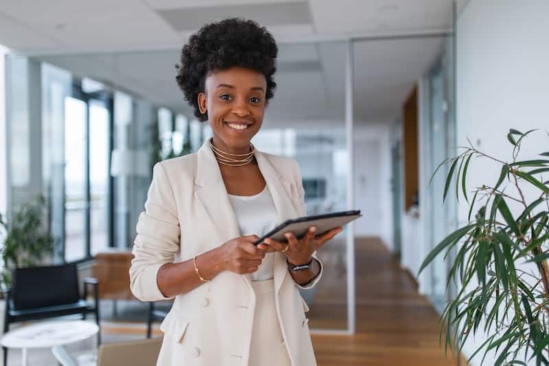 Smiling black woman with tablet